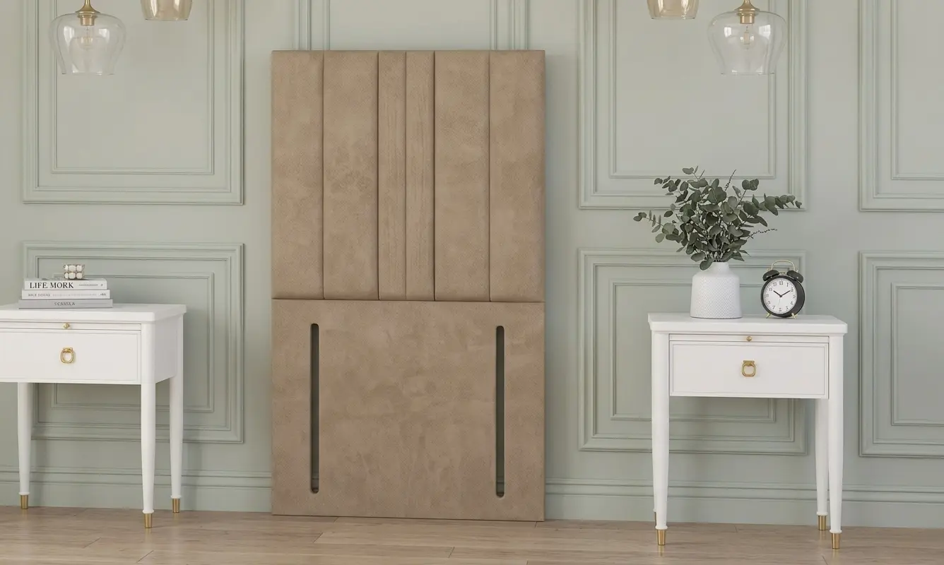 Chesterfield floor standing headboard in beige velvet, displayed between two black bedside tables in a classic interior.
