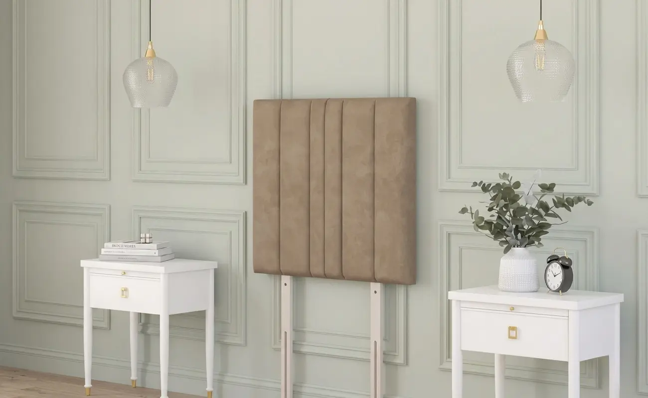  Beige plush velvet strutted headboard with a chesterfield design in a rustic cottage bedroom between two bedside tables.